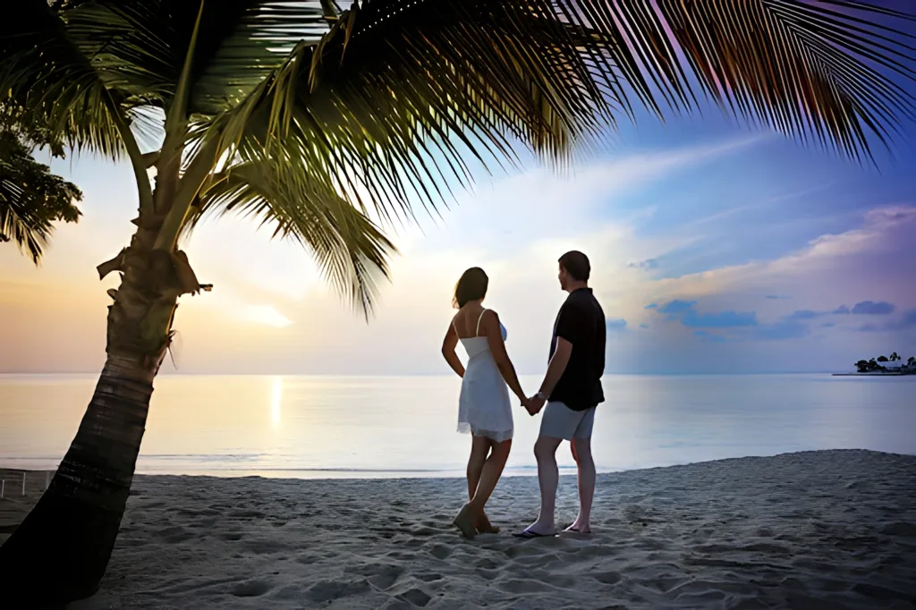Romantic couple holding hands on a tropical beach at sunset | East Winds Luxury Resort Saint Lucia