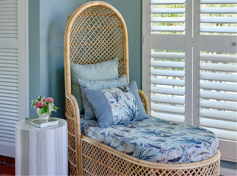 Cozy rattan lounge chair in a beachfront cottage at East Winds Resort, St. Lucia, perfect for relaxation during your all-inclusive stay