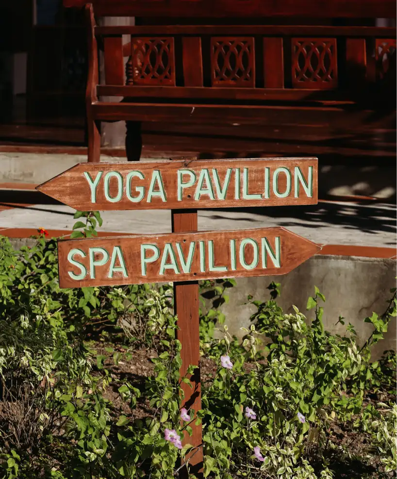 Sign directing guests to the Yoga Pavilion and Spa Pavilion at East Winds Resort, offering wellness and relaxation services