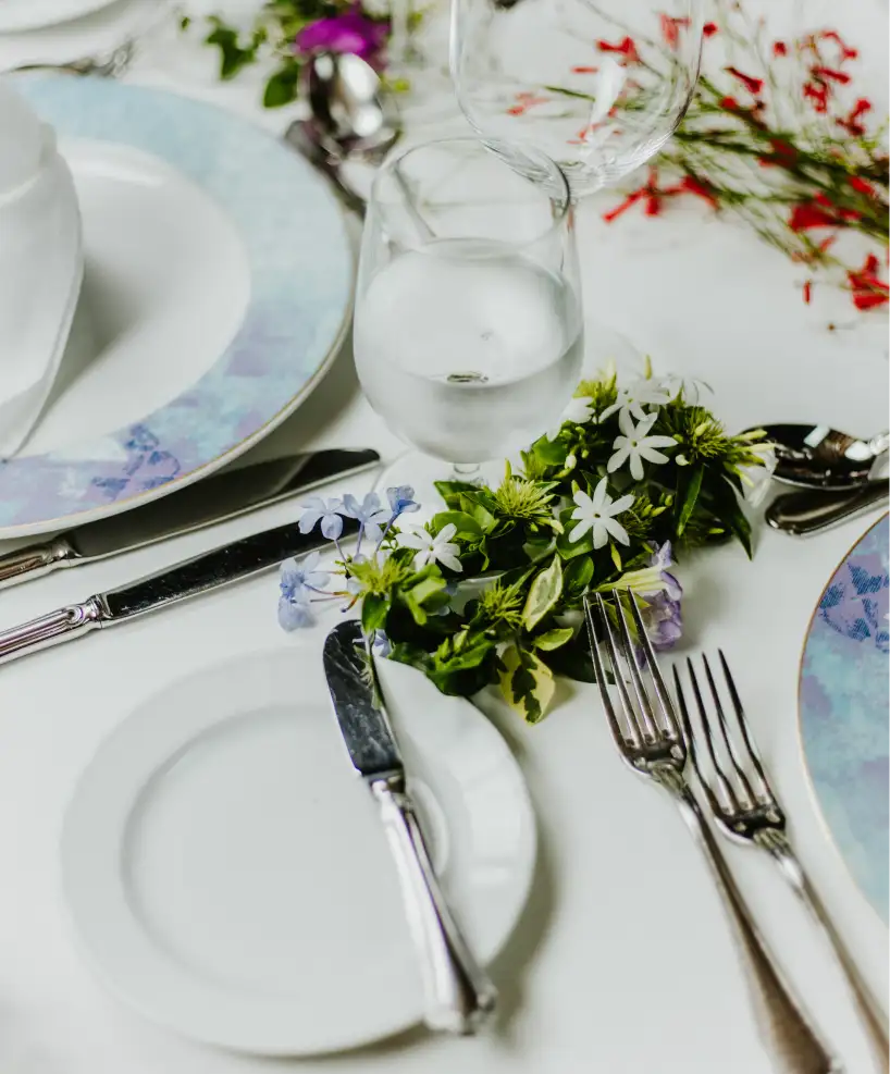 Elegant table setting with fresh flowers and water glasses, showcasing the fine dining experience at East Winds Resort