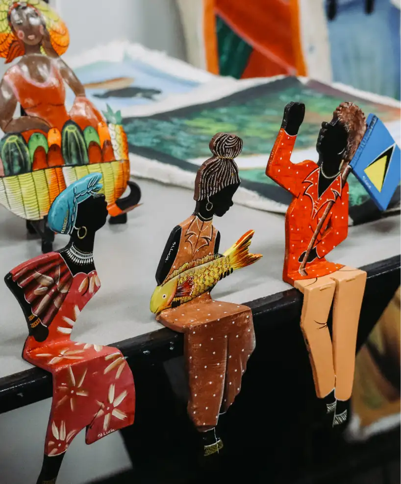 Handcrafted St. Lucia souvenirs, including colorful figurines representing local culture
