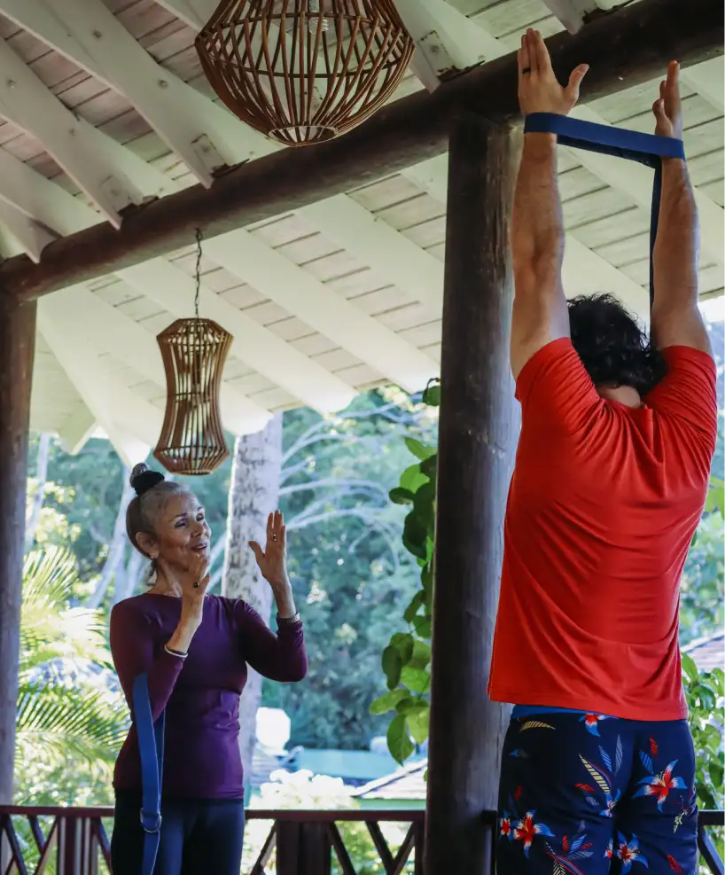 Guest participating in a private yoga session at the Yoga Pavilion at East Winds Resort, focusing on relaxation and wellness