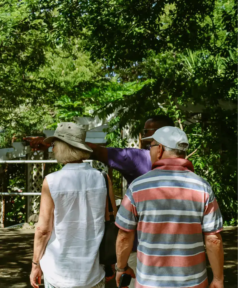 Elderly visitors exploring tropical grounds with a local guide | East Winds Luxury Resort Saint Lucia
