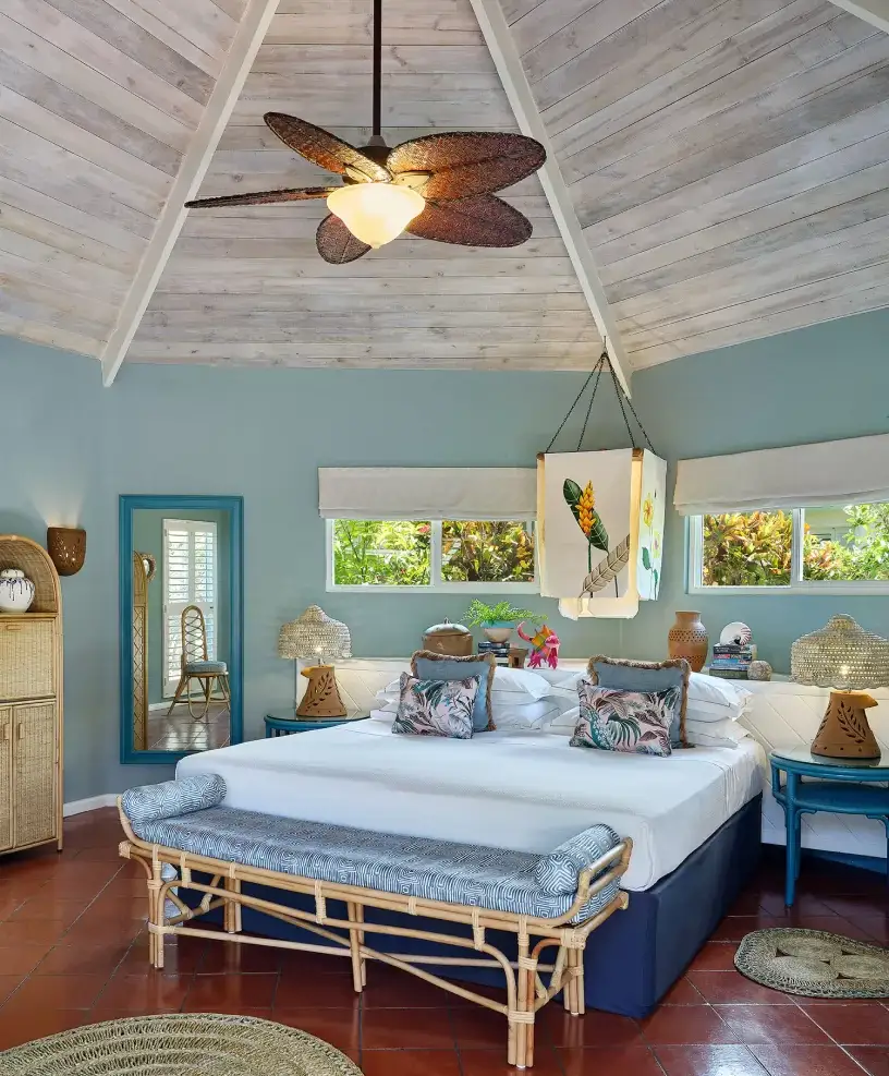 Vibrant resort bedroom with botanical decor and rattan furniture | East Winds Luxury Resort Saint Lucia